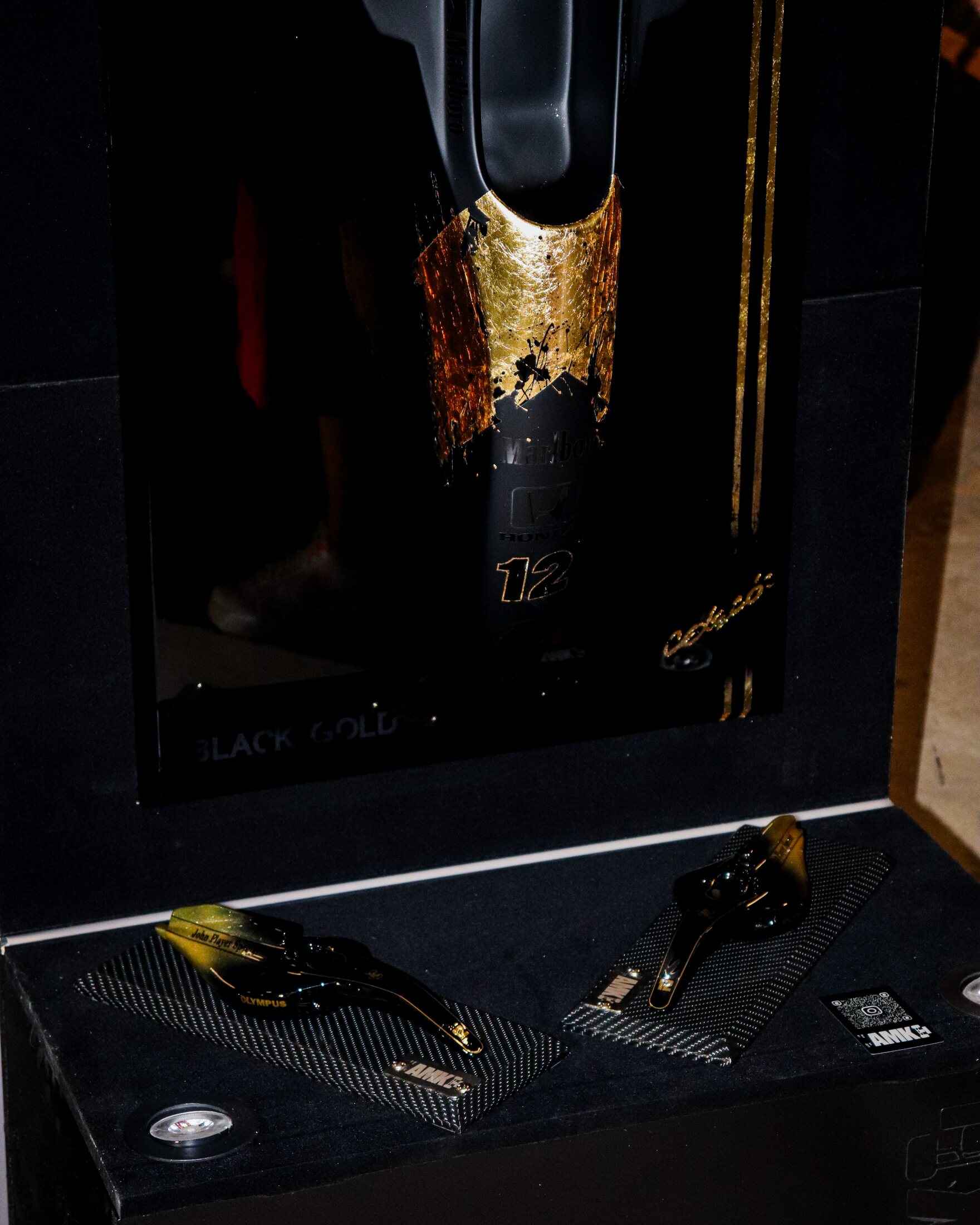Detalhe da obra Black Gold com acabamento preto fosco e aplicação dourada.
